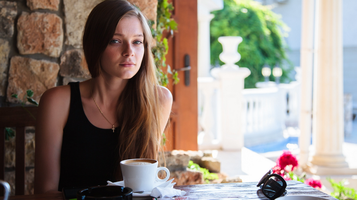 Woman sitting at a table with coffee