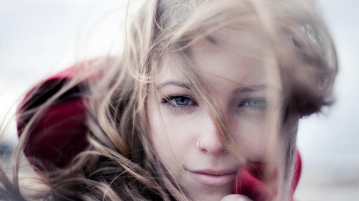 Woman with blonde hair and blue eyes in the wind