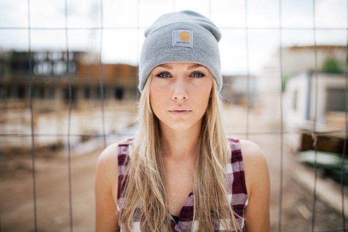 Woman wearing Carhartt beanie and plaid shirt
