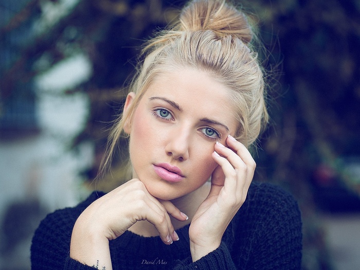 Blonde woman with blue eyes looking at viewer