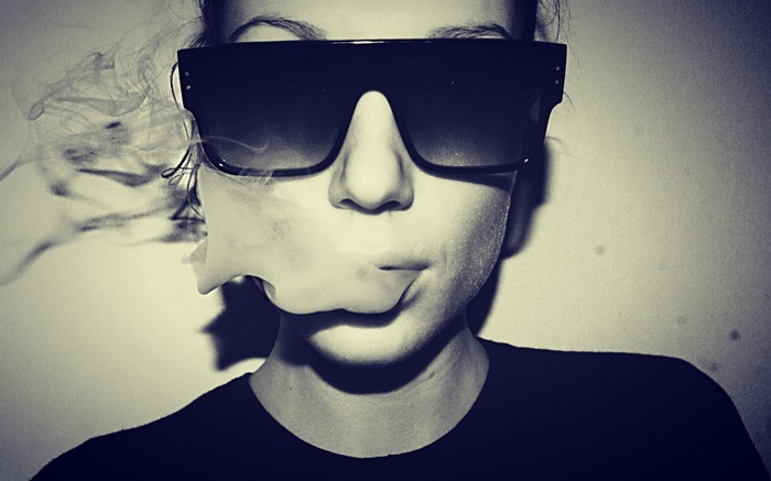 Woman wearing sunglasses smoking