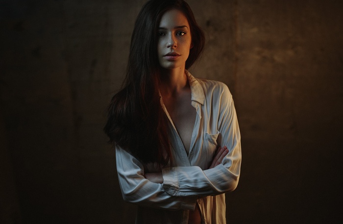 Woman with long dark hair and arms crossed