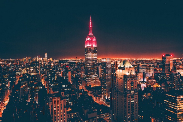Empire State Building illuminated red at night cityscape