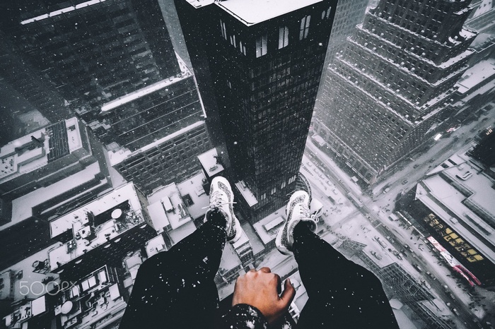 Snowy cityscape viewed from above a skyscraper