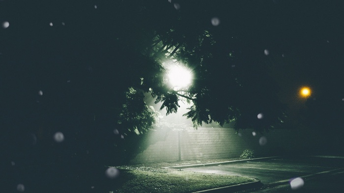 Streetlights illuminate a parking lot at night