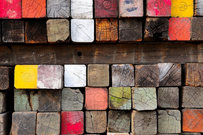 Stack of colorful and weathered wooden beams