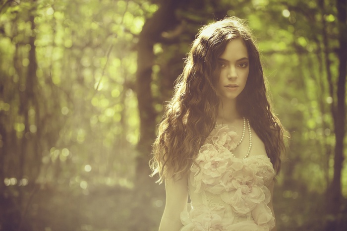 Woman with pearl necklace in a forest