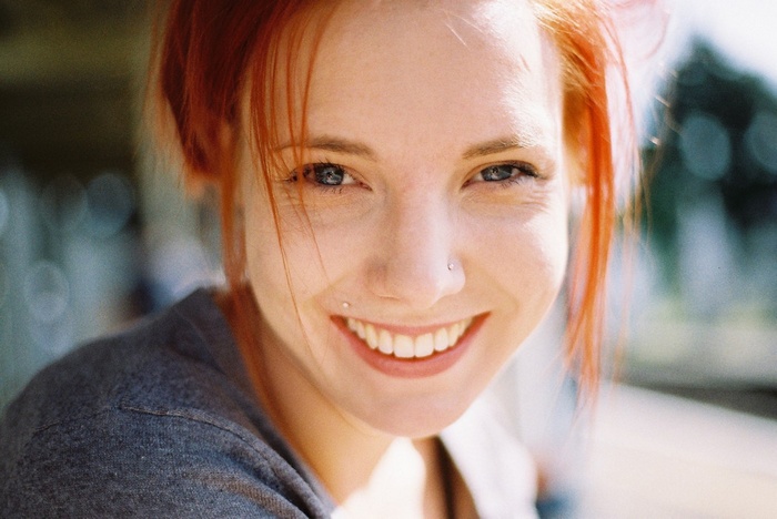 Redhead woman with blue eyes smiling