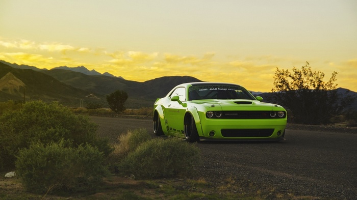 Green Dodge Challenger at Sunset in Desert Landscape
