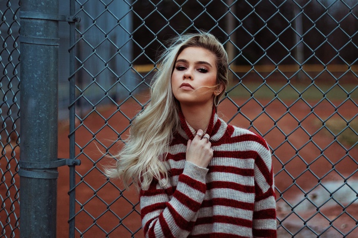 Woman with blonde hair wearing a striped sweater