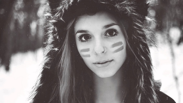 Woman with face paint and fluffy hat in winter