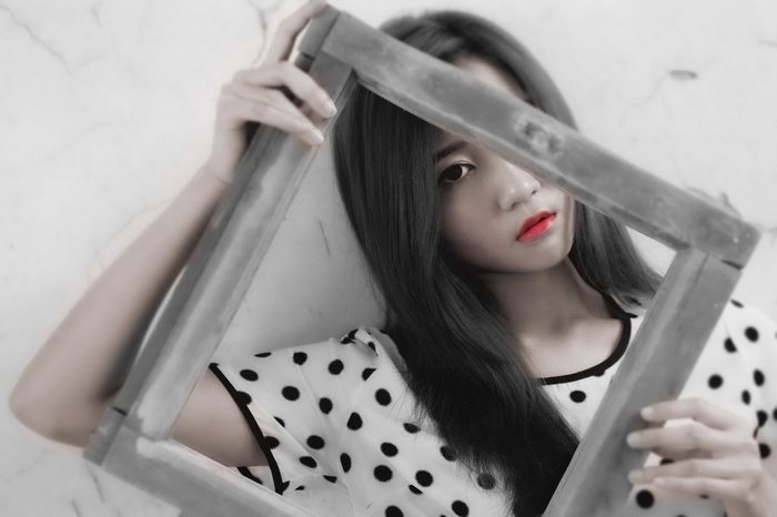 Asian model holding a picture frame