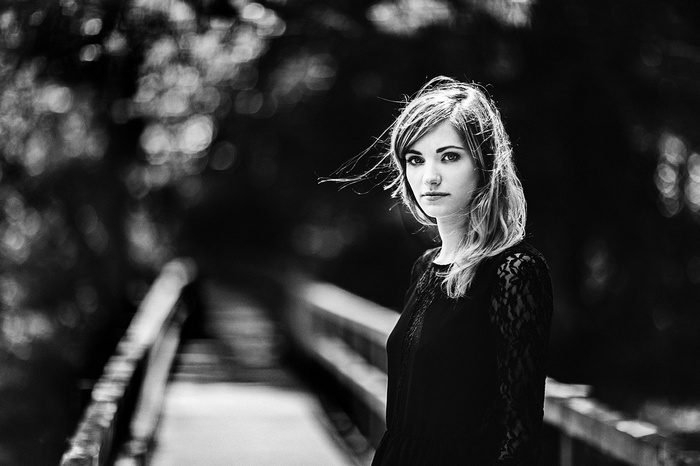 Monochrome portrait of a woman on a bridge