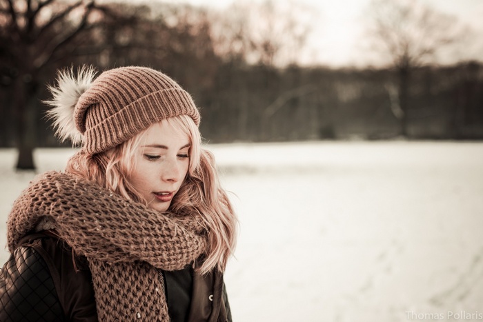 Woman in winter hat and scarf in snow