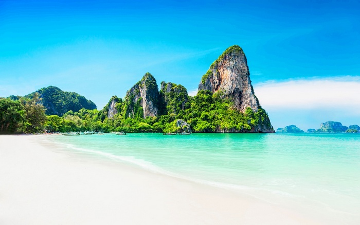 Tropical beach with limestone cliffs and turquoise water