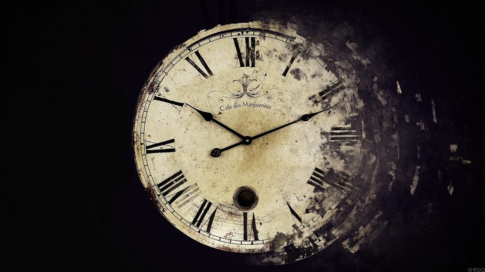 Old clock with Roman numerals disintegrating