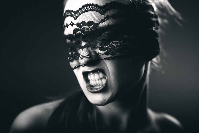 Woman wearing a black lace blindfold