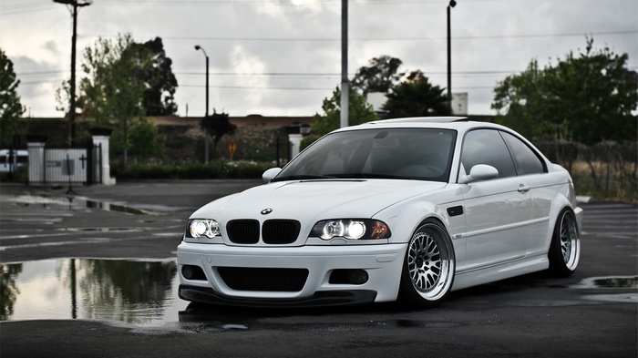 White BMW E46 M3 parked on wet asphalt
