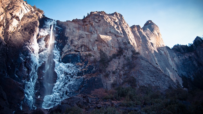 Waterfall cascading down a rocky mountain face