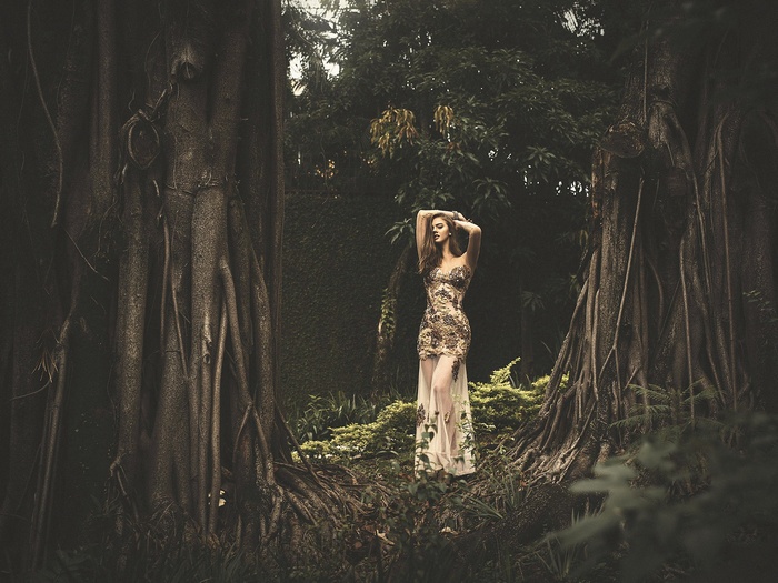 Emily Ribar posing with arms up in a forest