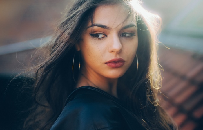 Portrait of a woman with long hair and hoop earrings