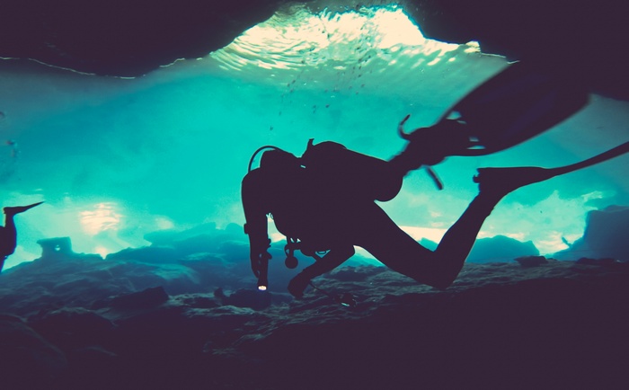 Divers exploring underwater cave