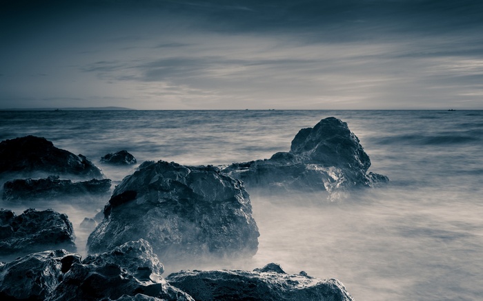Rocks in the sea with misty water