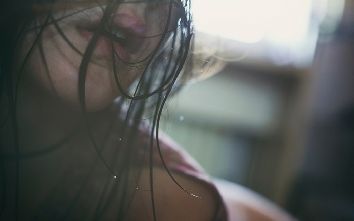 Close-up of a woman with wet hair and lips