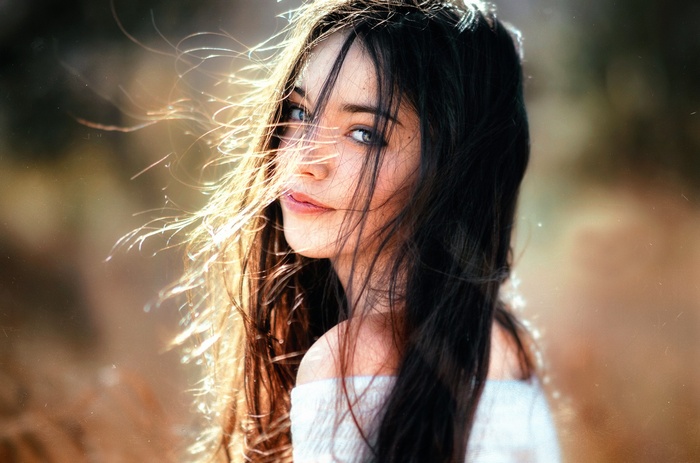 Woman with windblown hair and blue eyes