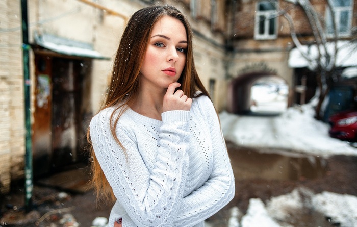 Woman in white sweater in the snow