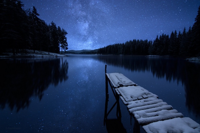 Snowy dock under the starry night sky