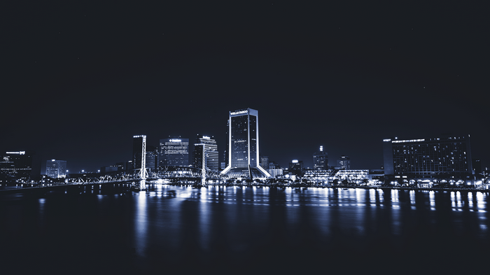 Jacksonville cityscape at night with river reflection
