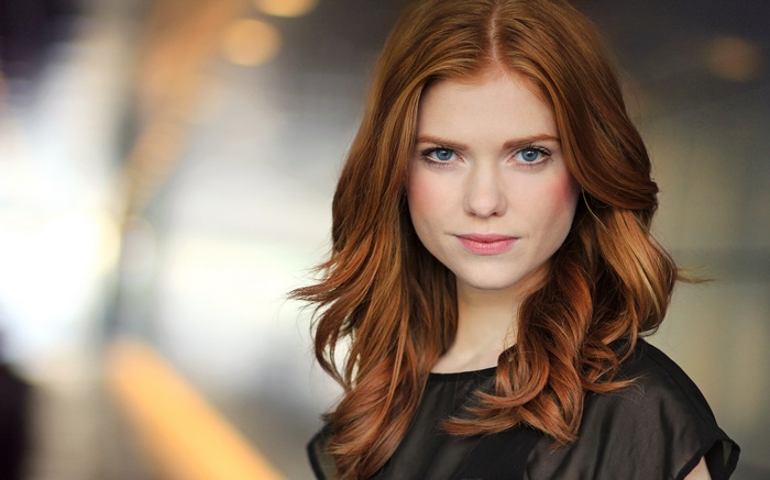 Megan West, a redhead woman with blue eyes