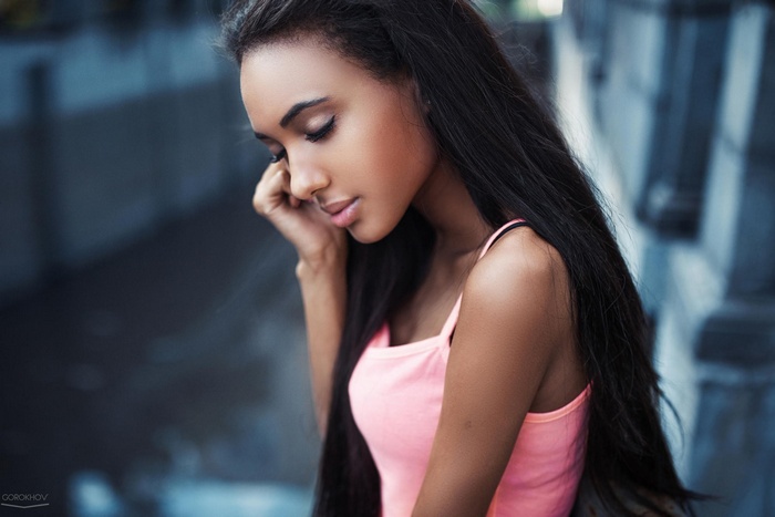 Model with long dark hair and closed eyes