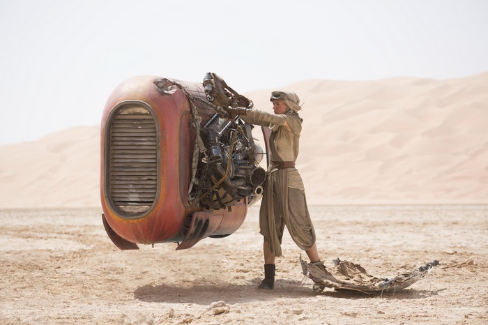 Rey working on a speeder in Star Wars: The Force Awakens