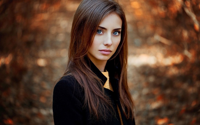 Ann Nevreva in a black coat with blue eyes
