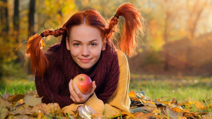 Pippi Longstocking with an apple in autumn