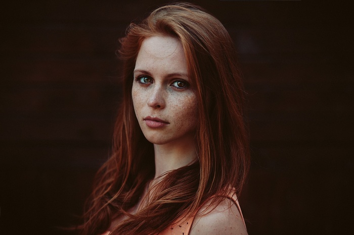 Redhead woman with freckles looking at viewer