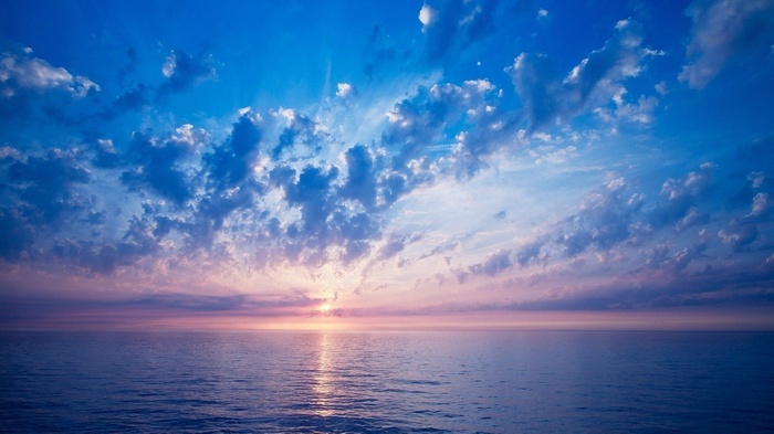 Sunset over the ocean with dramatic clouds