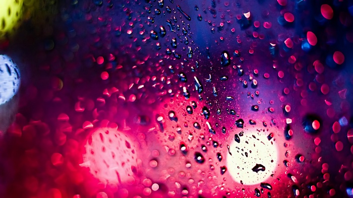 Water drops on glass with bokeh lights