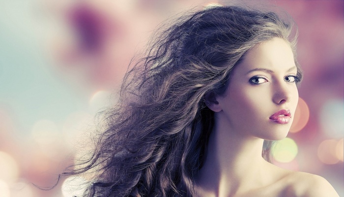 Woman with long curly hair and makeup