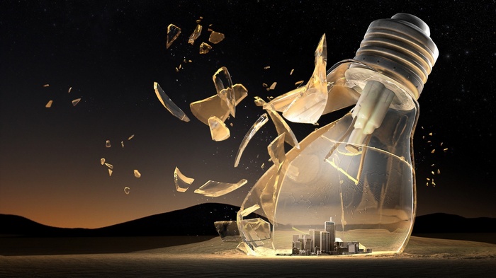 Broken lightbulb with city inside against starry night sky