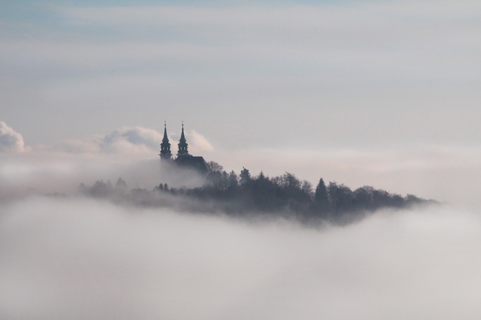 Church towers above clouds in Linz, Austria