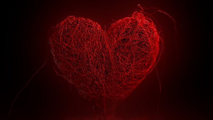 Red yarn heart on a dark background