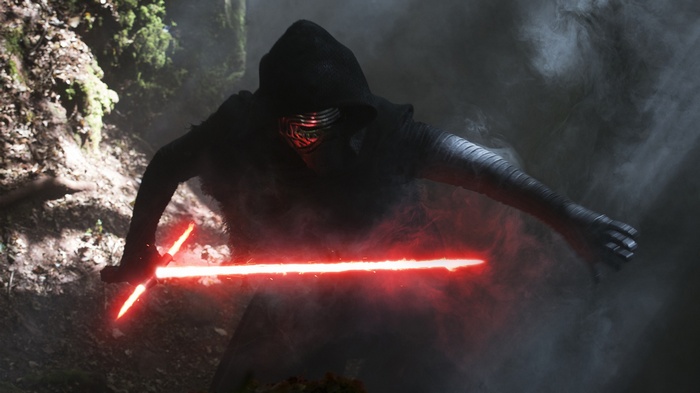 Kylo Ren with a red lightsaber in a forest