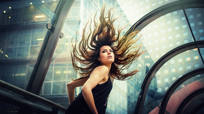 Woman with hair flying in a modern building