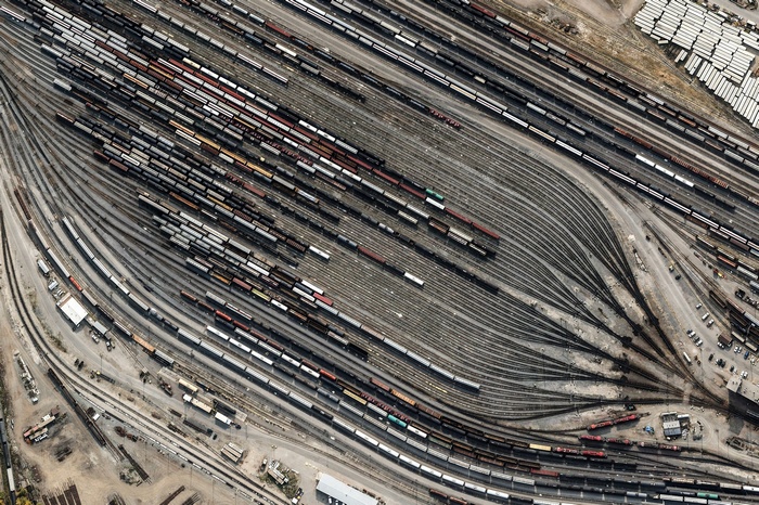 Aerial view of a busy train yard with many tracks and cars