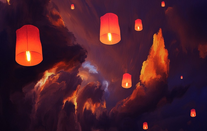 Red sky lanterns floating in a cloudy night sky