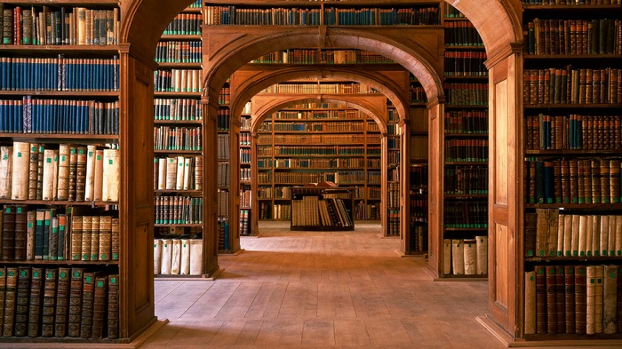 Interior of a grand library with wooden bookshelves