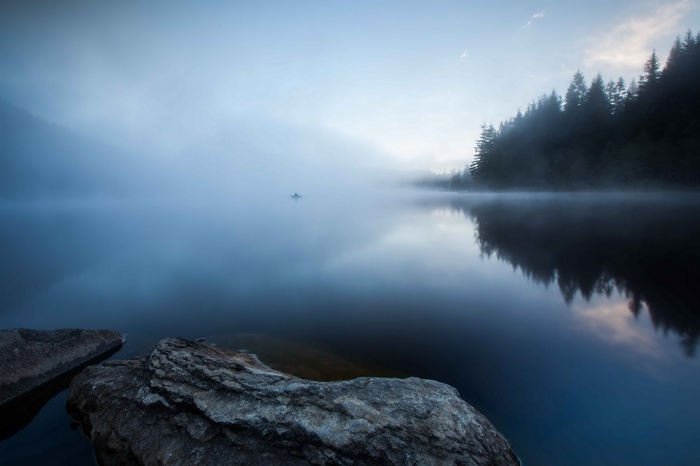 Misty lake with rocks and trees